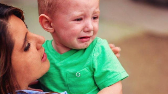 ילד פעוט בוכה בזרועות אימו